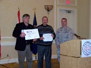 Gathering at the February luncheon are Kelley Crooks (l), senior director at SecureInfo Corporation, displaying a chapter scholarship check; guest speaker Dr. Ron Ross (c), senior scientist at the National Institute of Standards and Technology, holding his certificate of appreciation; and Lt. Col. David Wiley, USAF, acting chapter president.